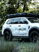Close up of the Lucas Creek D-Luxe aluminium hard shell roof top tent closed on the top of the Lucas Creek Ford Everest