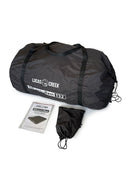 Black Lucas Creek AdventuRest 132 self-inflating mattress packed in a large carry bag, shown with its instruction manual and a smaller black drawstring bag.