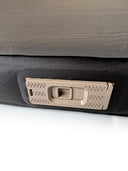 Close-up of the inflation pump on a Lucas Creek self-inflating mattress, showing a beige textured mechanism set into the black mattress fabric.